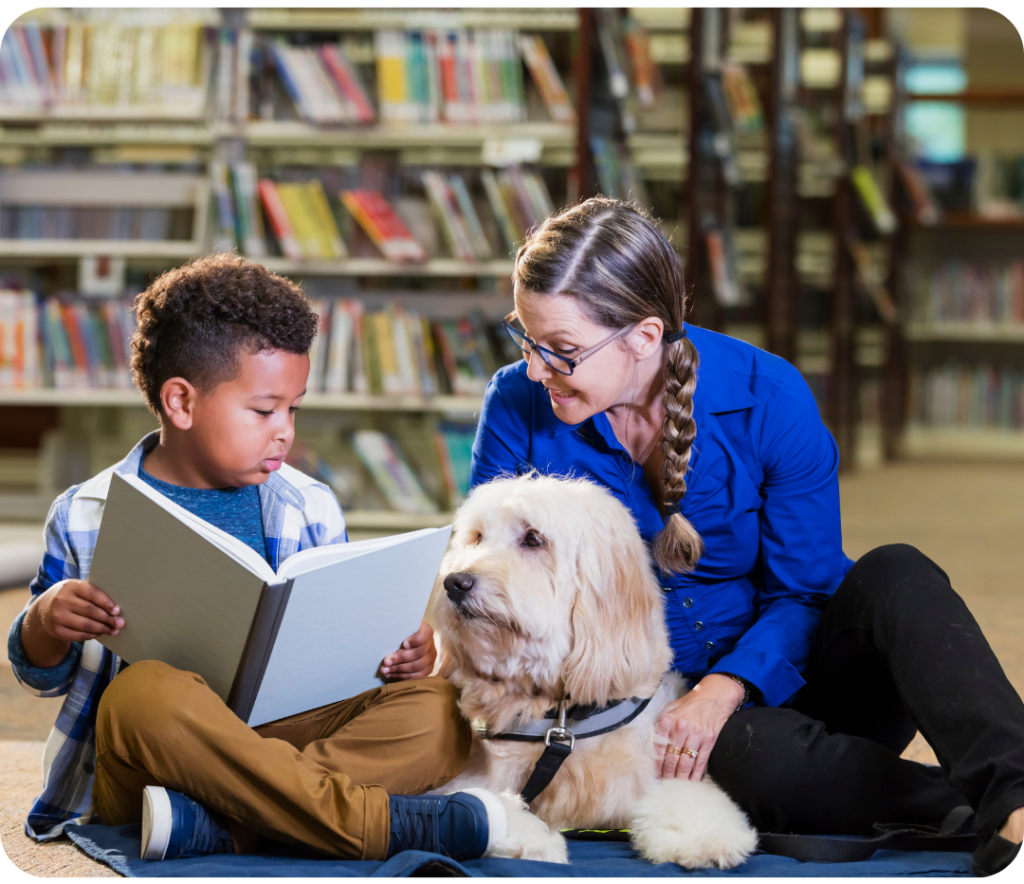 grade schoolers v4 Child reading to dog and adult in library